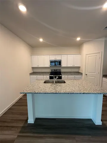 a view of a kitchen with granite countertop stainless steel appliances