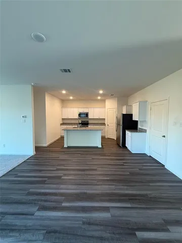 a view of kitchen and empty room