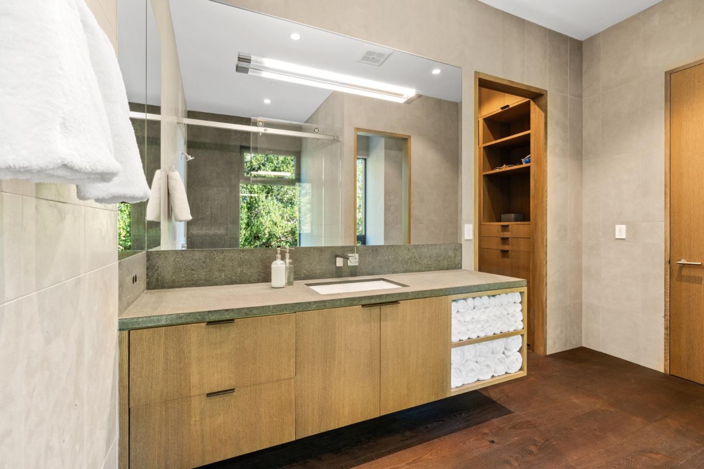 16951 Bohlman Road Saratoga, CA 95070 - Photo 39 of 48 a bathroom with a granite countertop sink and a mirror