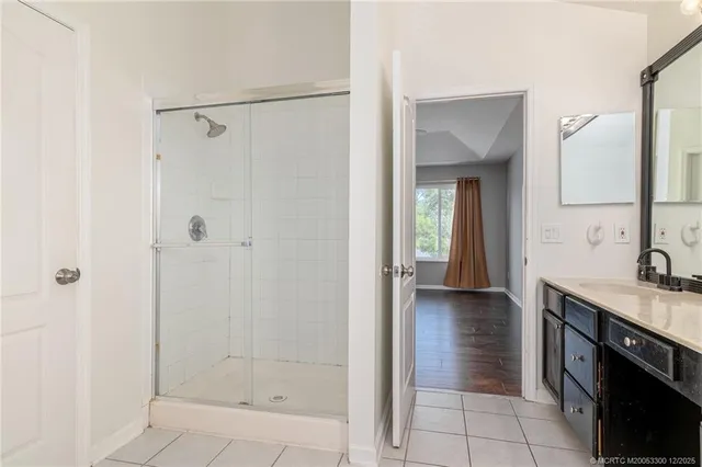 a bathroom with a sink a shower and a mirror