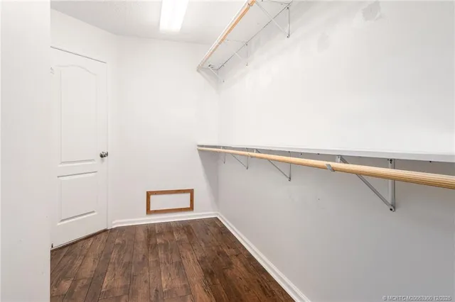 a view of a room with wooden floor