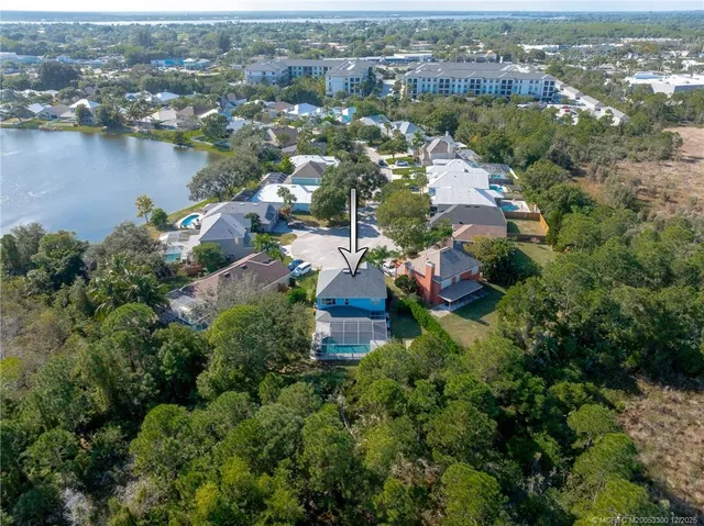 an aerial view of a houses with a lake view