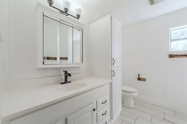 a bathroom with a sink toilet a mirror and shower