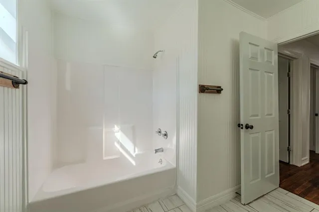 a bathroom with a bathtub and shower