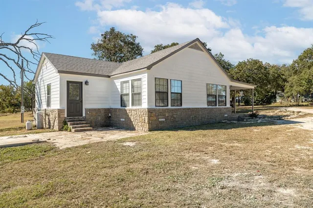 a view of a house with snow on the road
