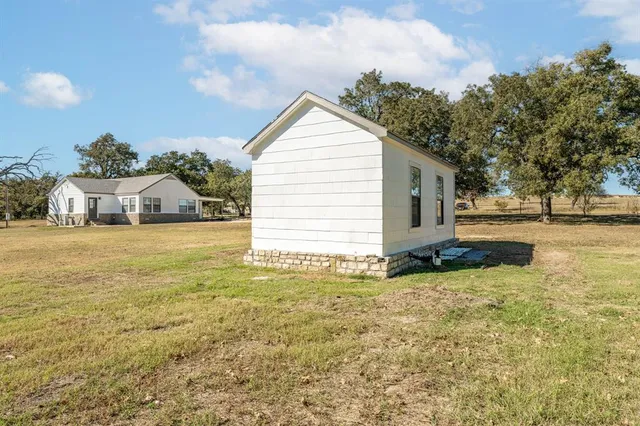 a view of a house with yard and sitting area