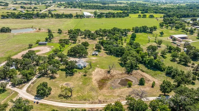 an aerial view of residential houses with outdoor space and seating area