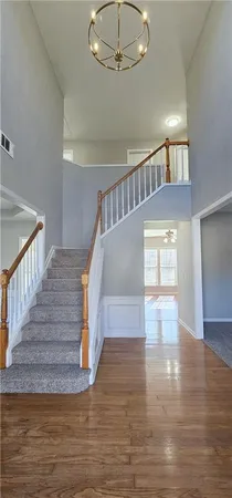 a view of entryway and hall with wooden floor