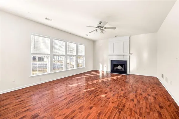 a large kitchen with white cabinets and white appliances