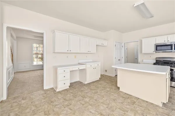 a kitchen with stainless steel appliances granite countertop a sink and a stove
