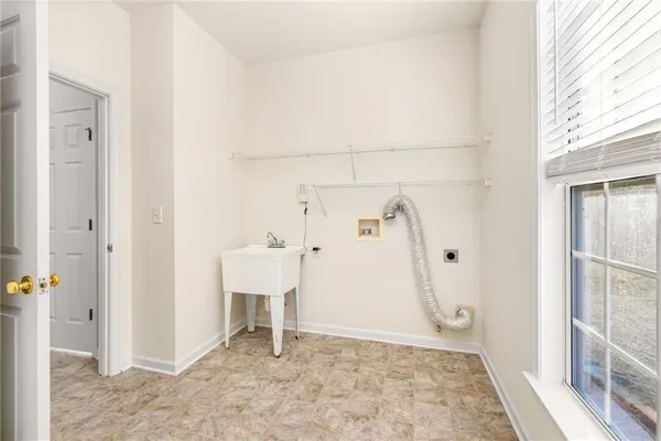 an empty room with windows and ceiling fan
