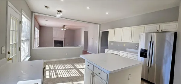 a kitchen with a refrigerator a sink and a window
