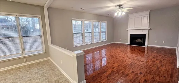 wooden floor chandelier and windows in a room