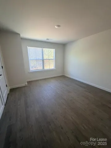 a bathroom with a granite countertop sink a toilet and a tub