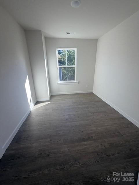 405 15th Avenue Southwest Hickory, NC 28602 - Photo 9 of 11 an empty room with wooden floor and windows