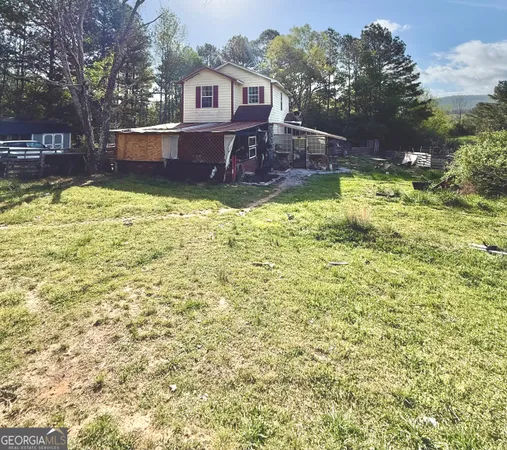 a view of a house with a yard table and chairs