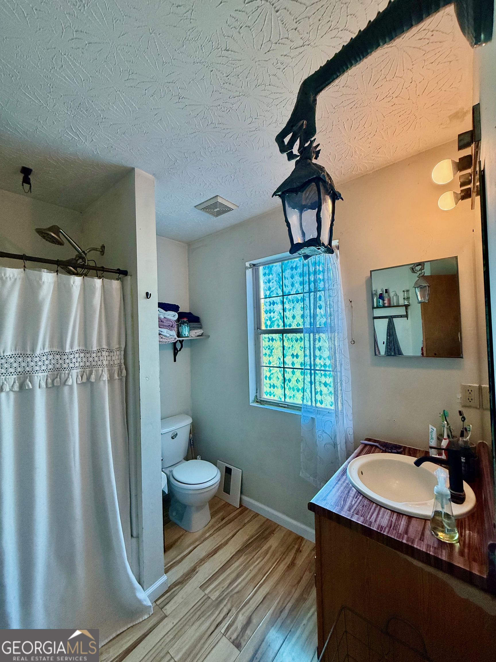 1449 Price Bridge Road Lyerly, GA 30730 - Photo 11 of 32 a bathroom with a granite countertop sink toilet and shower