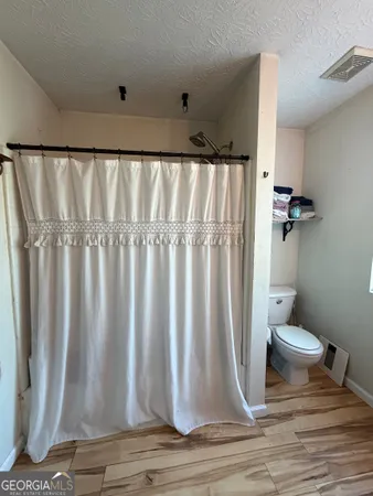 a bathroom with a shower curtain and a sink