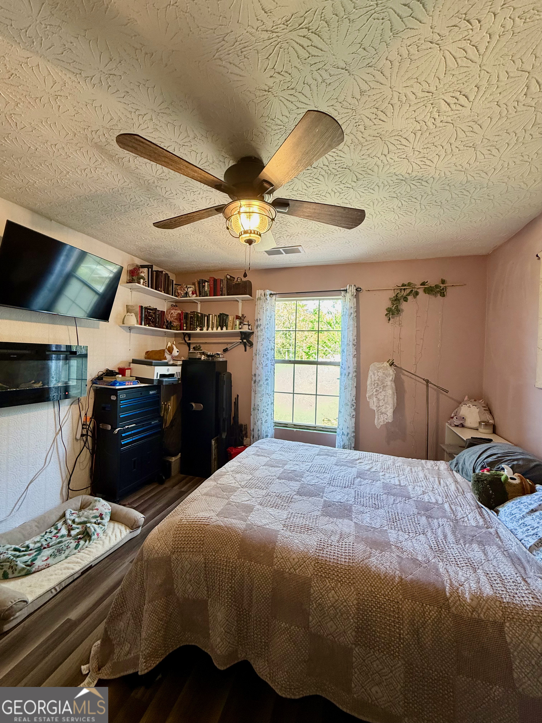 1449 Price Bridge Road Lyerly, GA 30730 - Photo 16 of 32 a bedroom with a bed and a chandelier
