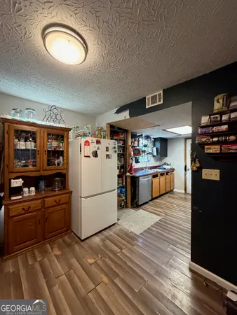 a kitchen with refrigerator and cabinets