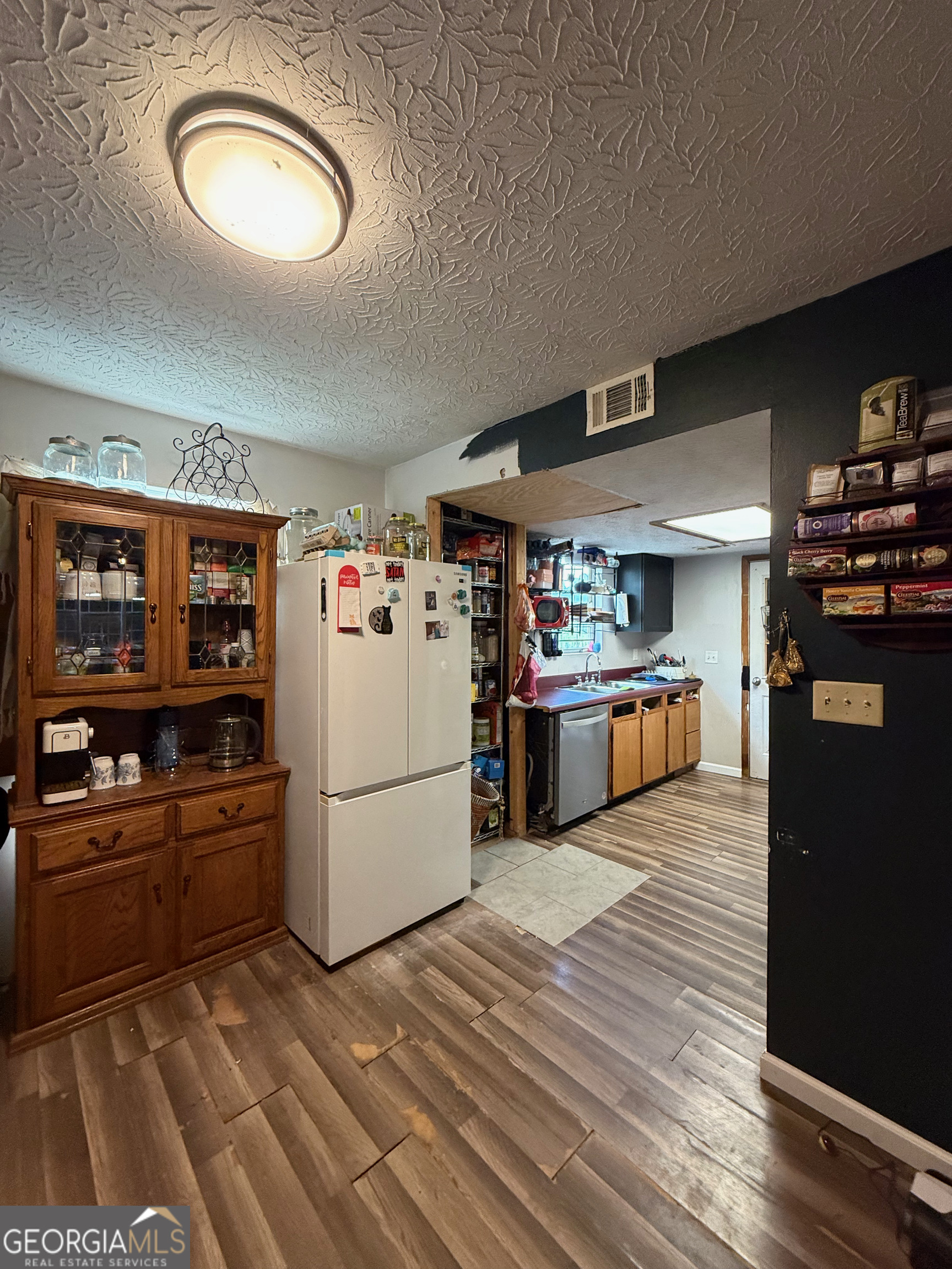 1449 Price Bridge Road Lyerly, GA 30730 - Photo 6 of 32 a kitchen with refrigerator and cabinets