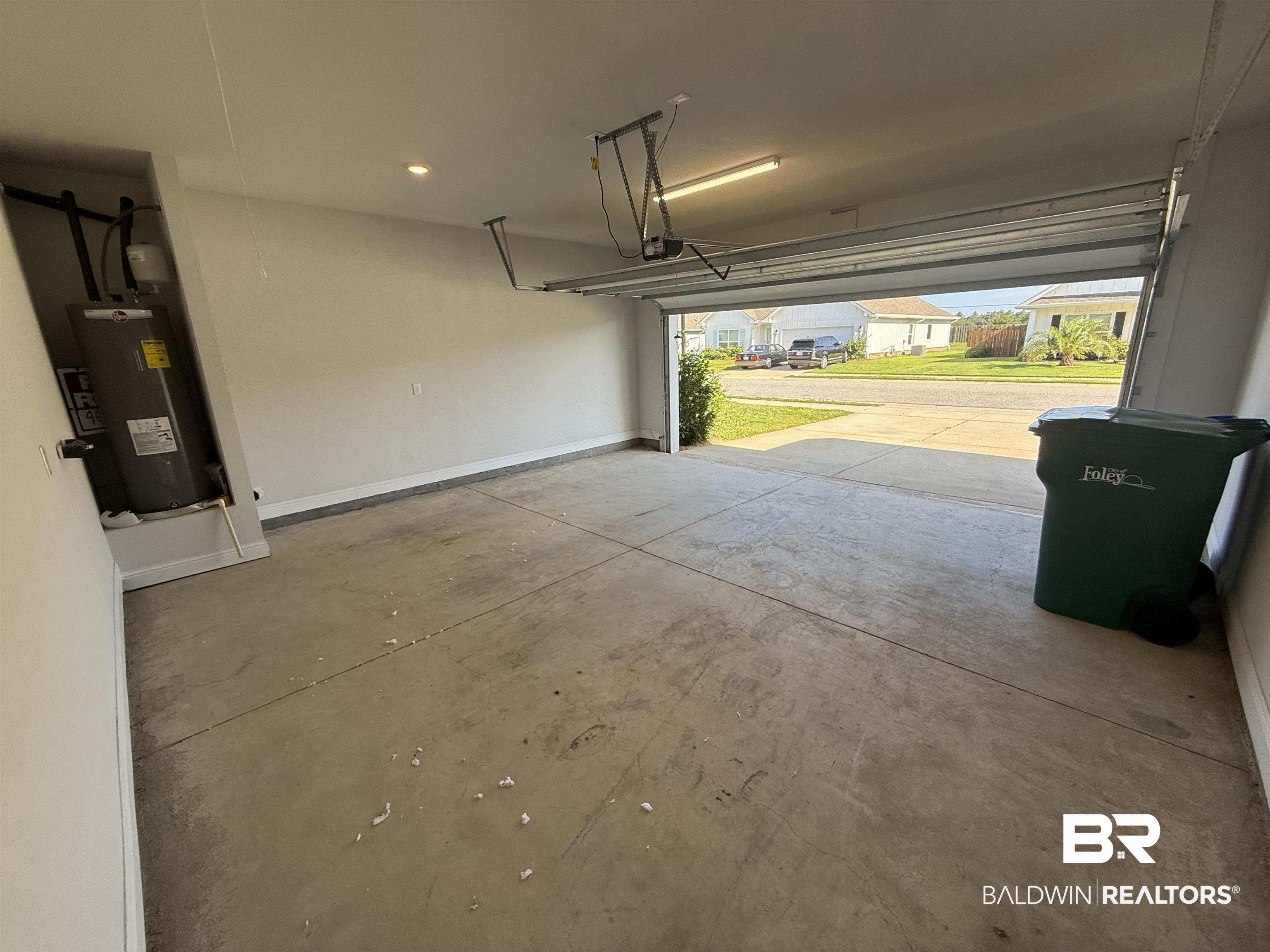 23247 Lieutenant Avenue Foley, AL 36535 - Photo 45 of 47 Spacious garage featuring a concrete floor, overhead lighting, and an automatic garage door opener