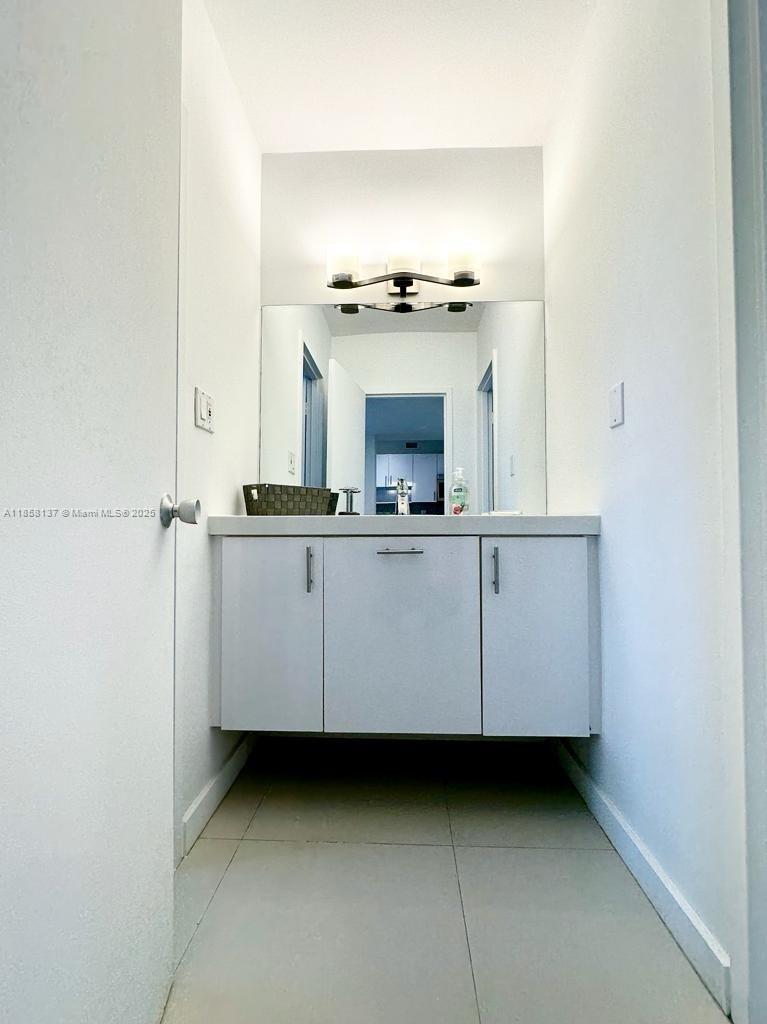 100 Lincoln Road, Unit 1406 Miami Beach, FL 33139 - Photo 11 of 14 a bathroom with a sink and a mirror