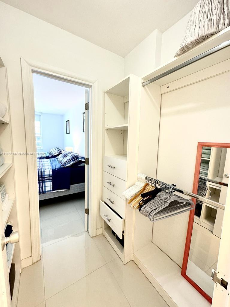 100 Lincoln Road, Unit 1406 Miami Beach, FL 33139 - Photo 13 of 14 a view of walk in closet with clothes and shoes