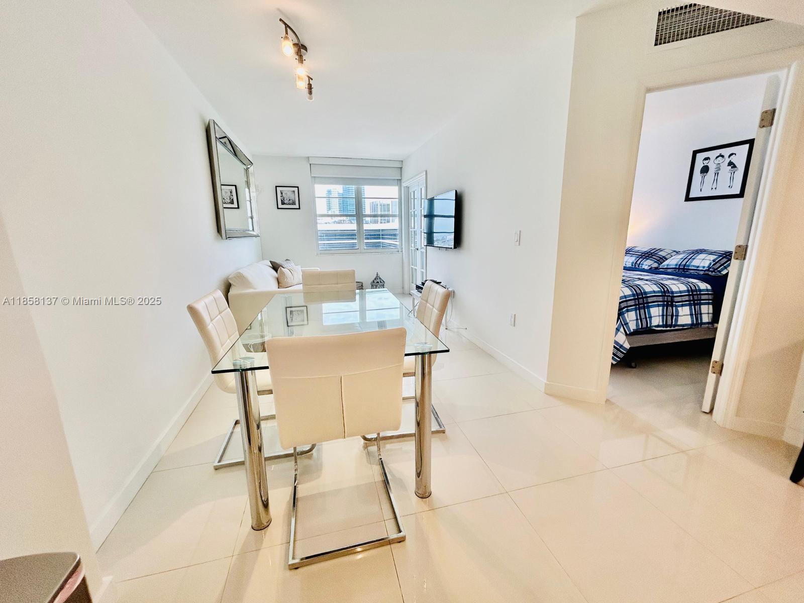 100 Lincoln Road, Unit 1406 Miami Beach, FL 33139 - Photo 3 of 14 a dining room with furniture and window