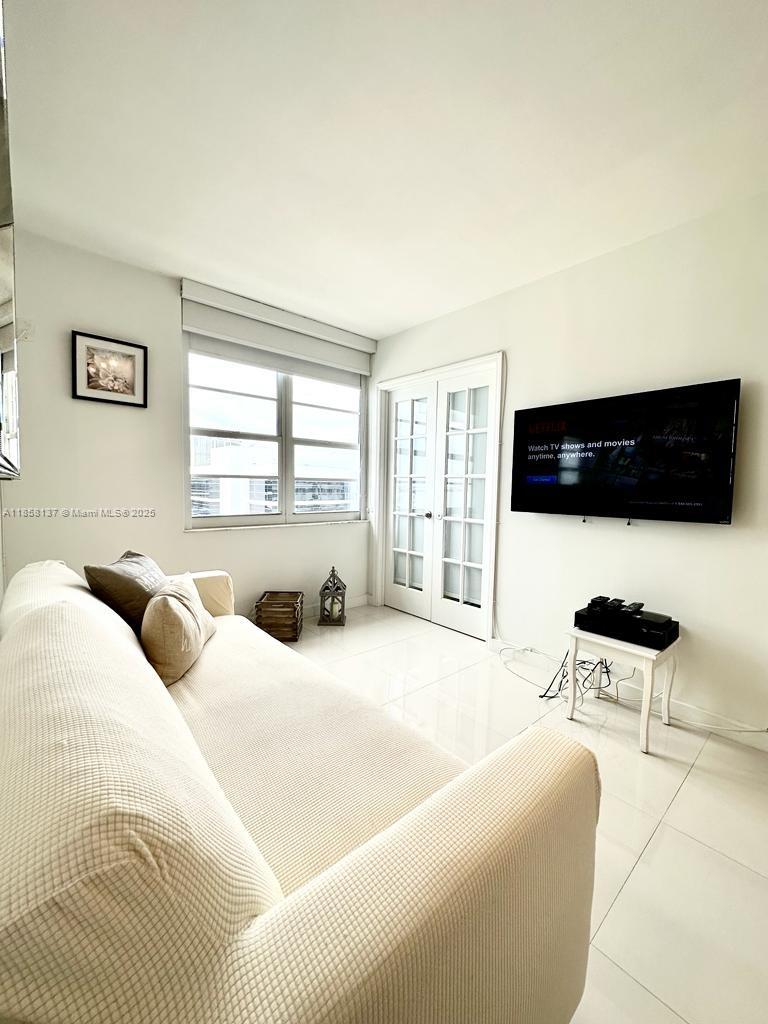 100 Lincoln Road, Unit 1406 Miami Beach, FL 33139 - Photo 4 of 14 a living room with furniture and a flat screen tv