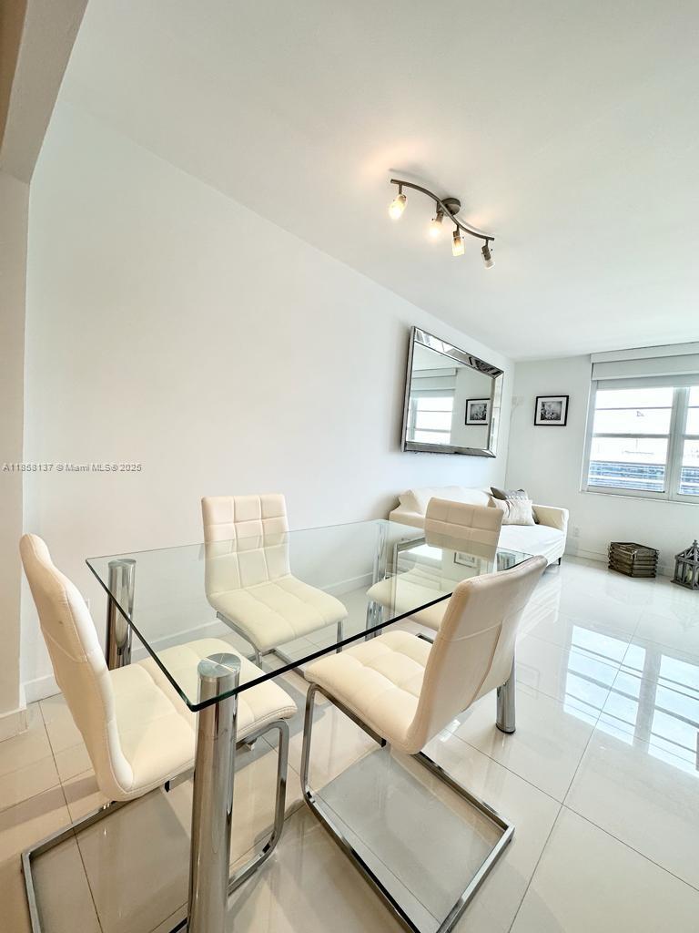 100 Lincoln Road, Unit 1406 Miami Beach, FL 33139 - Photo 5 of 14 a living room with furniture and a table