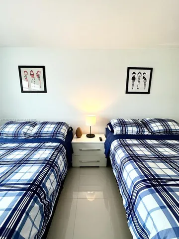 a bedroom with double bed and a two large window