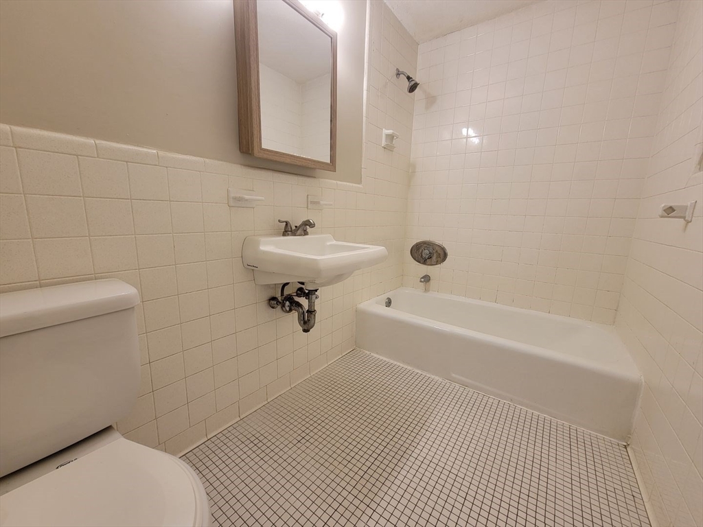 83 Pleasant Street, Unit 24 Marlborough, MA 01752 - Photo 3 of 6 a bathroom with a sink toilet and shower