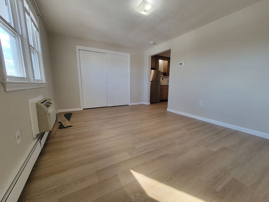 83 Pleasant Street, Unit 24 Marlborough, MA 01752 - Photo 5 of 6 an empty room with closet and mirror