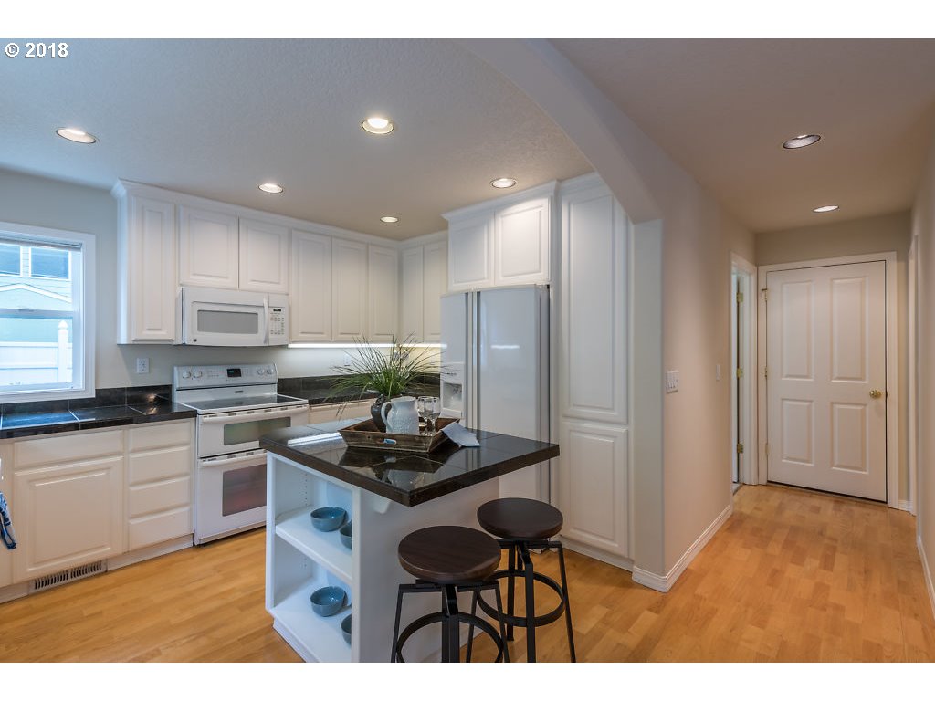 7571 Southwest Mapleleaf Street Portland, OR 97223 - Photo 14 of 32 a kitchen that has a sink cabinets counter space and stainless steel appliances