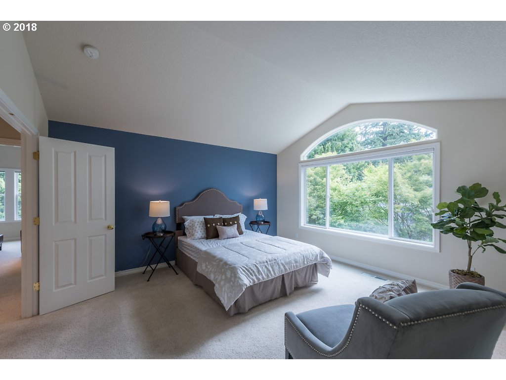 7571 Southwest Mapleleaf Street Portland, OR 97223 - Photo 16 of 32 a bedroom with furniture and a large window