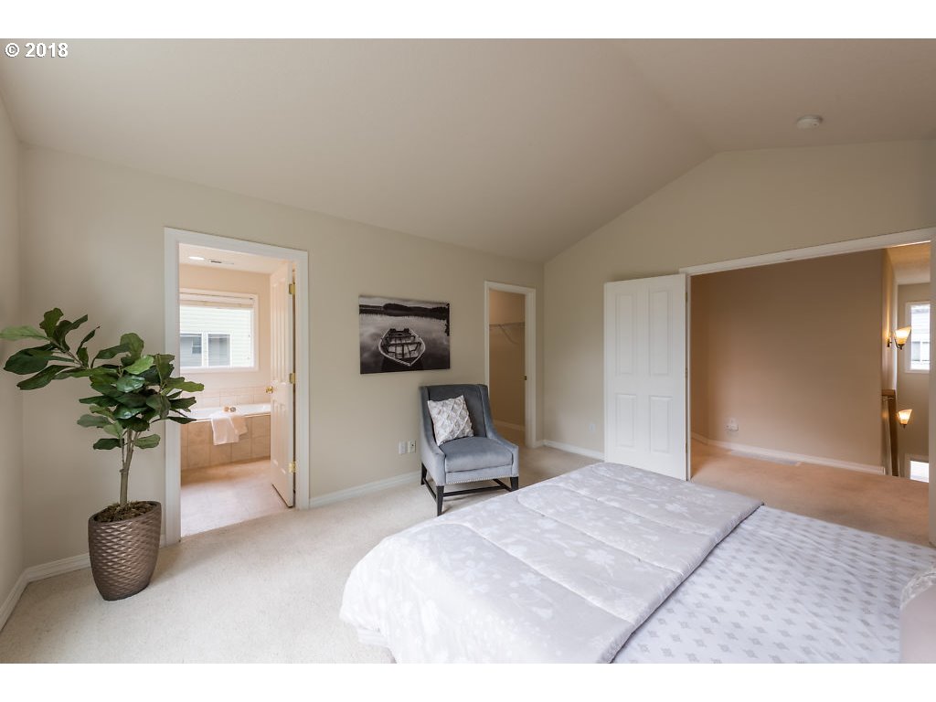7571 Southwest Mapleleaf Street Portland, OR 97223 - Photo 17 of 32 a bedroom with furniture and a potted plant