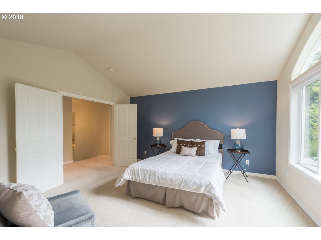 7571 Southwest Mapleleaf Street Portland, OR 97223 - Photo 18 of 32 a bedroom with a bed and a large mirror