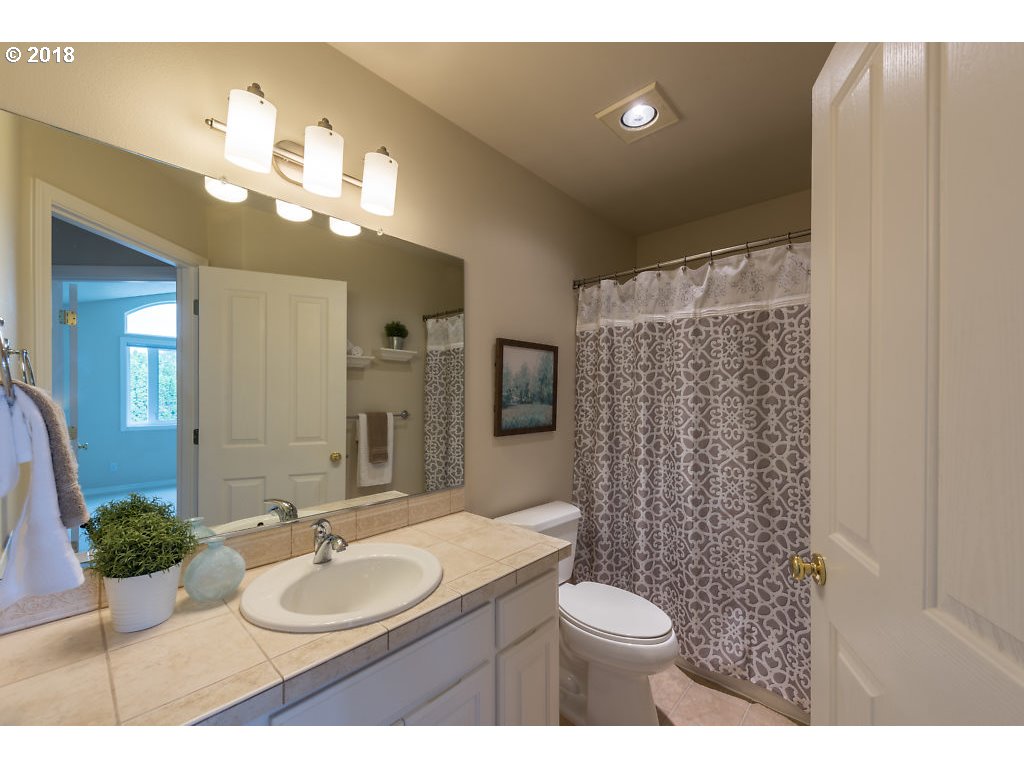 7571 Southwest Mapleleaf Street Portland, OR 97223 - Photo 25 of 32 a bathroom with a toilet sink and mirror