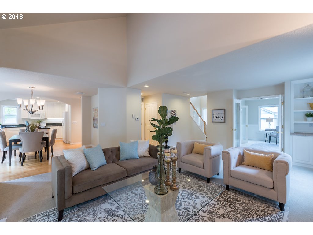 7571 Southwest Mapleleaf Street Portland, OR 97223 - Photo 4 of 32 a living room with furniture and a chandelier