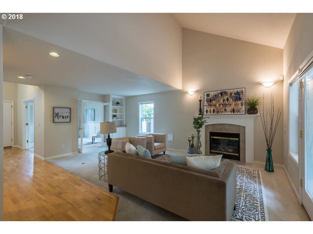 7571 Southwest Mapleleaf Street Portland, OR 97223 - Photo 5 of 32 a living room with furniture and a fireplace