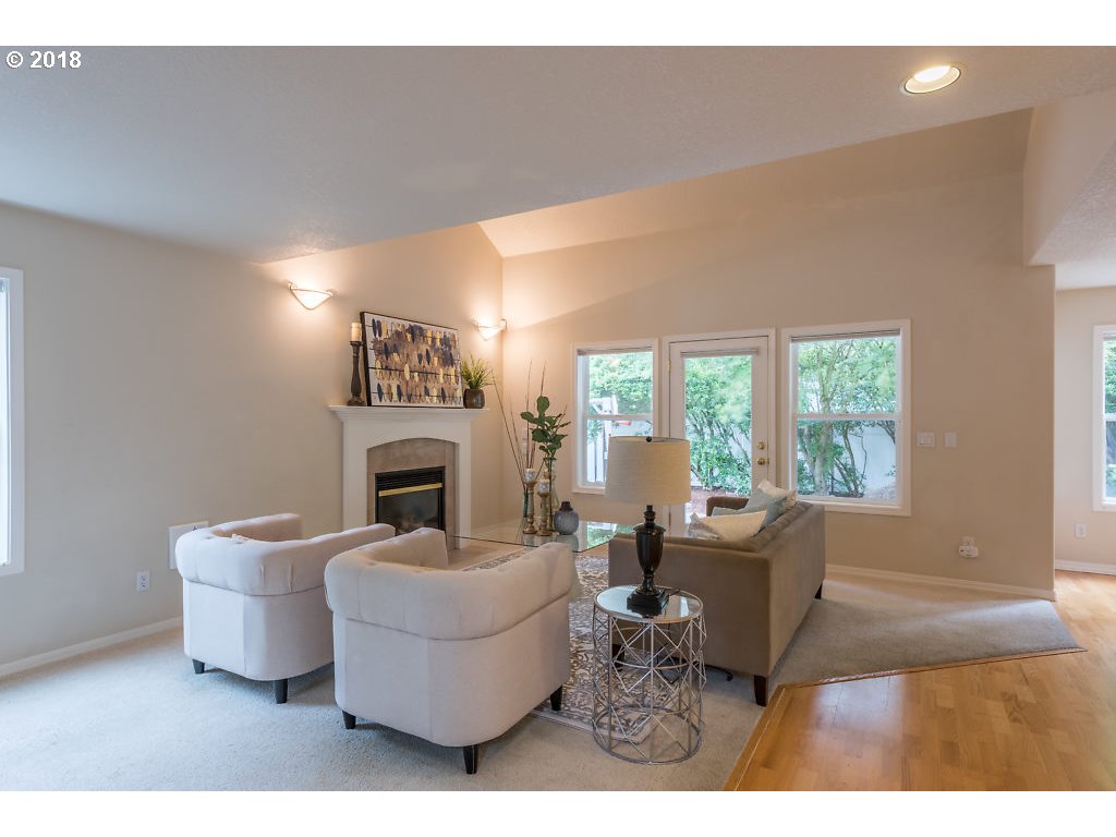 7571 Southwest Mapleleaf Street Portland, OR 97223 - Photo 6 of 32 a living room with furniture a fireplace and a large window