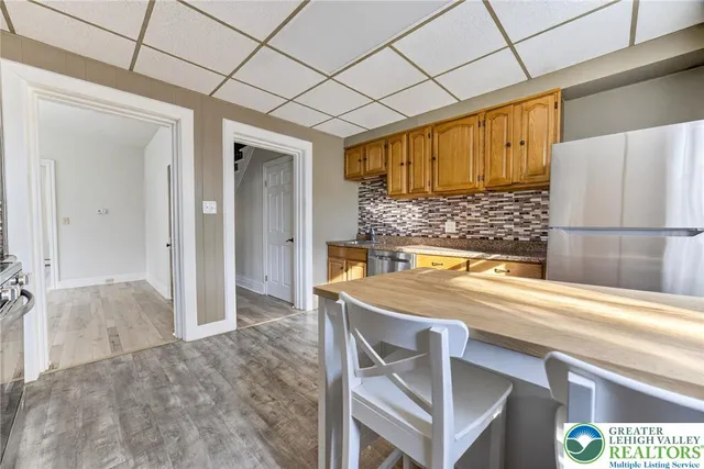 a room with a sink and a refrigerator