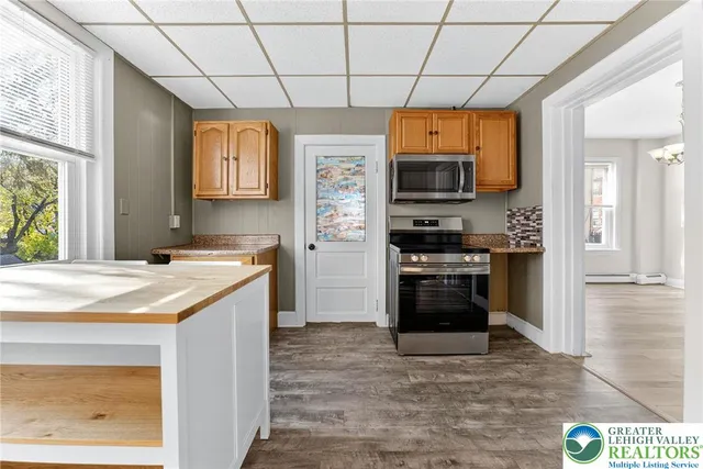 a kitchen that has a sink and a stove in it