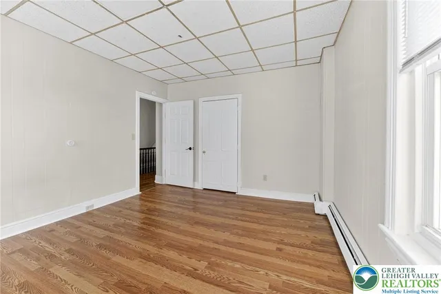 a view of an empty room and wooden floor