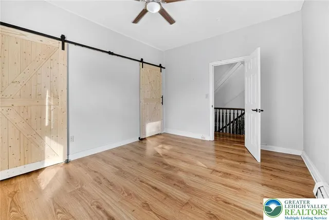 a view of empty room with wooden floor