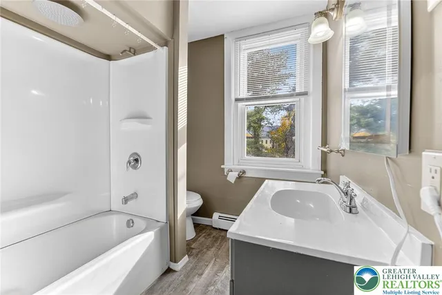 a bathroom with a tub sink and window