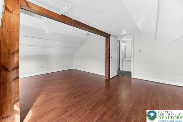 a view of hallway with wooden floor
