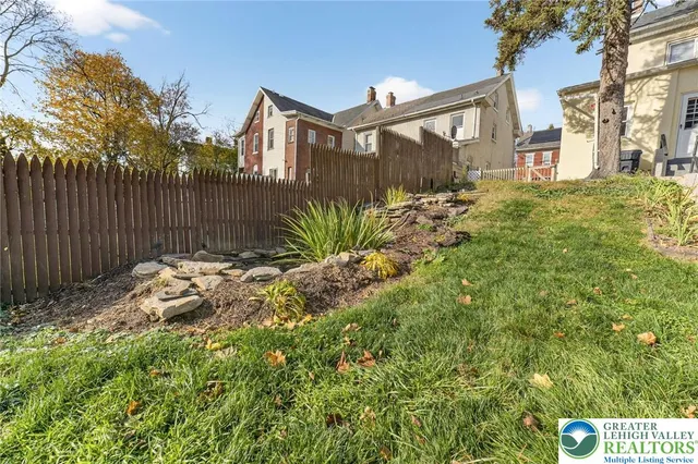a view of a house with a yard and plants