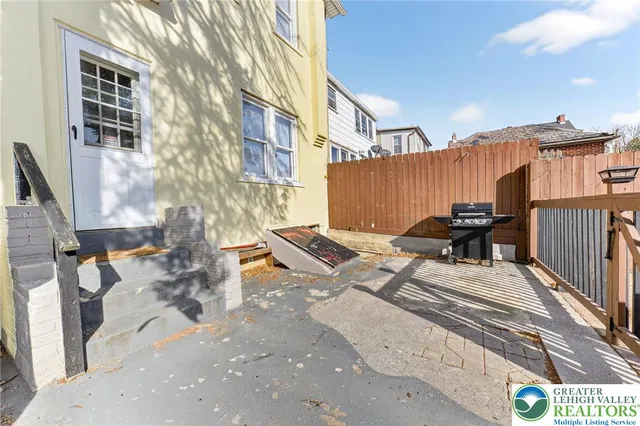 a view of a patio with a table and chairs